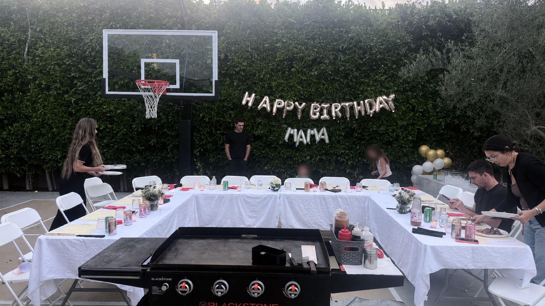 Hibachi grill setup in front of a backyard birthday party