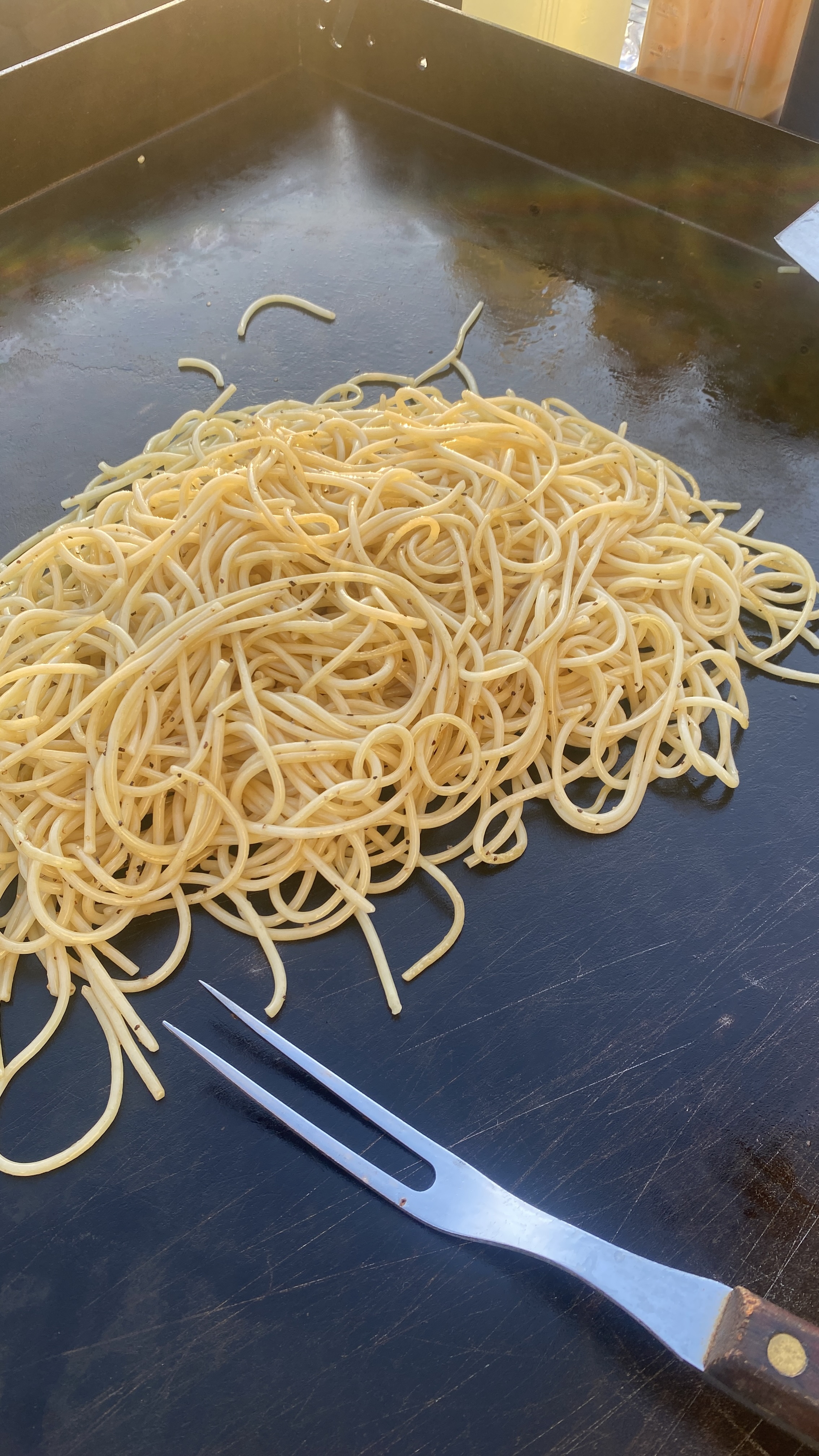 Noodles cooking on a real hibachi grill